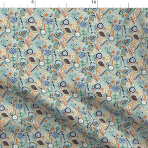 May include: A seamless pattern featuring a variety of abstract shapes and designs in shades of blue, green, orange, and yellow on a light blue background.