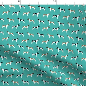 May include: A teal blue fabric with a repeating pattern of white, black, and brown dogs. The dogs are in a standing position with their tails up.