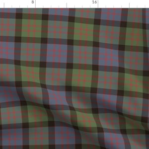 May include: A green, blue, and black plaid fabric with a red thread woven throughout. The fabric is folded in the bottom right corner.