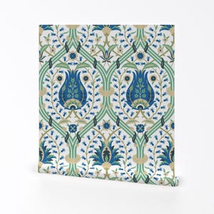 May include: A white background with a repeating pattern of blue, green, and gold floral designs. The pattern features stylised tulips and leaves.