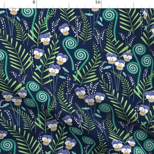 May include: A fabric pattern featuring a dark blue background with a repeating floral design. The design includes purple and white pansies, green ferns, and white lily of the valley flowers. The overall pattern is a botanical theme.