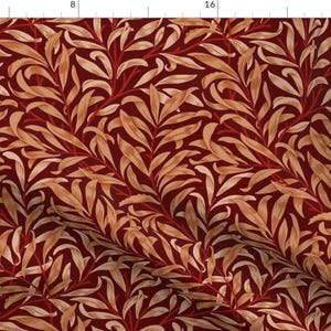 May include: A fabric with a repeating pattern of stylized leaves and vines. The design features light tan leaves and red vines against a deep burgundy background. The overall effect is a classic, botanical print.