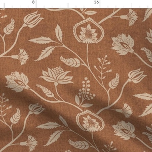 May include: A brown fabric with a white floral pattern. The pattern features stylized flowers, leaves, and stems.