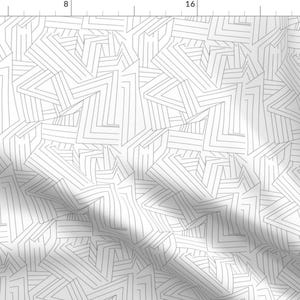 May include: A white background with a black and white geometric pattern of overlapping lines and shapes.