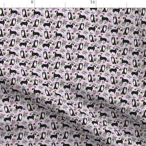 May include: A seamless pattern featuring Bernese Mountain Dogs in black and white, standing in a field of purple flowers. The background is a light purple color.