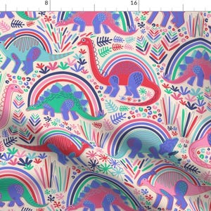 May include: A colourful fabric design featuring dinosaurs and rainbows. The dinosaurs are in shades of pink, red, green, and blue, and the rainbows are in shades of blue, green, and pink. The background is a light cream colour.