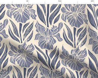 May include: Fabric featuring a repeating pattern of stylized irises and leaves in shades of blue and white on a cream background. The design has a vintage, block-print style, suitable for various craft projects.