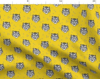 May include: A yellow fabric with a repeating pattern of black and white tiger faces. The background is a solid yellow color with small white dots.