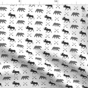 May include: A seamless pattern featuring black moose and bear silhouettes on a white background. The pattern also includes a repeating design of crossed arrows.