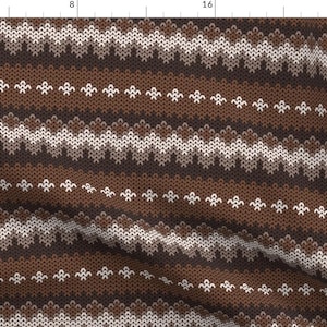 May include: A brown and white knit fabric with a repeating pattern of interlocking waves and small diamond shapes.