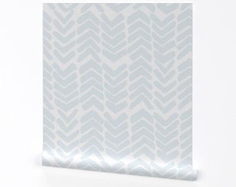 May include: A roll of light blue wallpaper with a white chevron pattern.