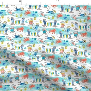 May include: A white fabric with a repeating pattern of otters wearing striped shirts and holding strings of fish. The otters are swimming in blue water with red crabs and yellow seaweed. The background is white.