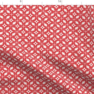 May include: Red and white geometric pattern with a repeating star design. The pattern is made up of white stars on a red background.