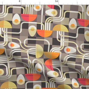 May include: A seamless pattern featuring a geometric design of eggs, noodles, and bowls in shades of brown, yellow, orange, and red.