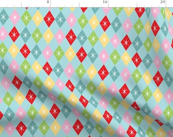 May include: A repeating pattern of colorful diamond shapes with white stars in the center. The diamonds are red, yellow, green, pink, and blue on a light blue background.