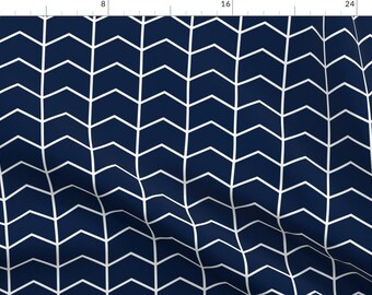 May include: A navy blue and white chevron pattern fabric. The pattern is made up of white arrows pointing to the right and left, alternating in a repeating pattern.
