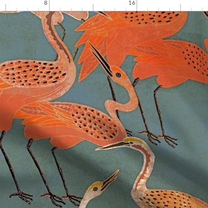 May include: A fabric design featuring stylized orange birds with black legs and beaks against a teal background. The birds have detailed wing patterns and are arranged in a repeating pattern, creating a decorative textile.