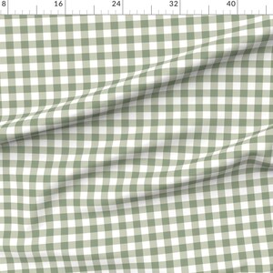 May include: A white and sage green gingham fabric with a subtle texture. The fabric is folded in half and has a slight wrinkle.