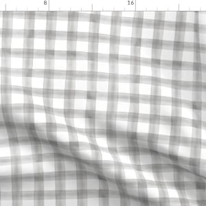 May include: A white and gray gingham fabric with a subtle watercolor effect. The fabric has a soft, drapey texture and is perfect for a variety of sewing projects.