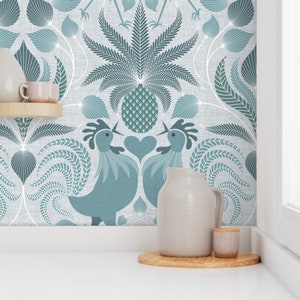 May include: A teal blue wallpaper with a repeating pattern of stylized pineapples, leaves, and roosters. The wallpaper is shown in a kitchen setting with a pitcher and a small jar on a wooden coaster.