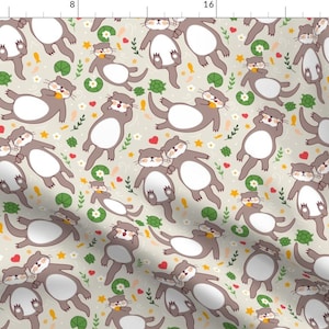 May include: A seamless pattern featuring cute cartoon otters in various poses, including cuddling, swimming, and sleeping. The otters are brown with white bellies and are surrounded by green leaves, yellow flowers, and pink hearts on a light beige background.