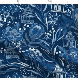 May include: A blue and white floral pattern with pagoda-style structures and protea flowers. The design is repeated throughout the fabric.