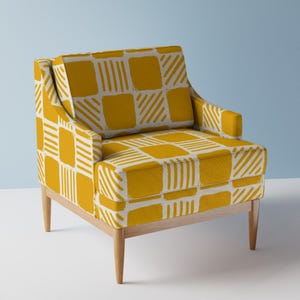 May include: A yellow armchair with a white geometric pattern. The chair has wooden legs and a slightly curved back.