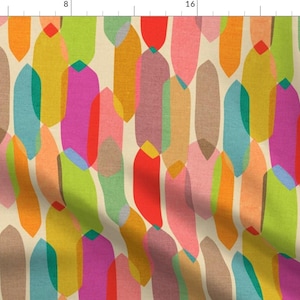 May include: A fabric textile featuring a repeating pattern of elongated, rounded vertical shapes in shades of red, pink, orange, yellow, lime green, teal, and brown, set against a light cream background, with a visible ruler along the top edge.