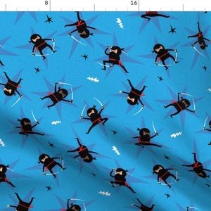 May include: A blue fabric with a repeating pattern of black ninjas throwing stars. The ninjas are wearing red sashes and are throwing white stars.