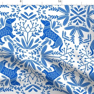 May include: A seamless pattern featuring blue stylized dogs and floral designs on a white background. The pattern is perfect for fabric, wallpaper, or wrapping paper.