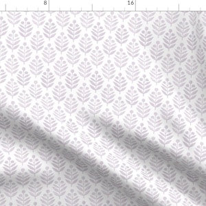 May include: A white fabric with a repeating pattern of light purple stylized leaves. The leaves are arranged in a staggered pattern.