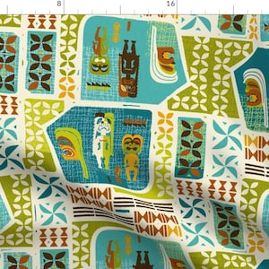 May include: Fabric with a repeating pattern of stylized tiki figures, geometric shapes, and floral motifs in shades of teal, brown, orange, and green on an off-white background. The design has a retro, mid-century modern aesthetic.