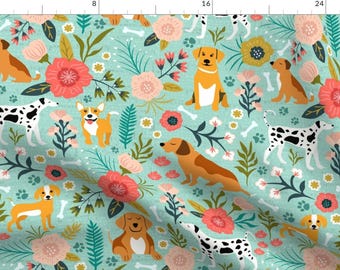 May include: A teal blue fabric with a repeating pattern of dogs and flowers. The dogs are in various breeds and colours, including dalmatian, dachshund, and terrier. The flowers are pink, red, and yellow.