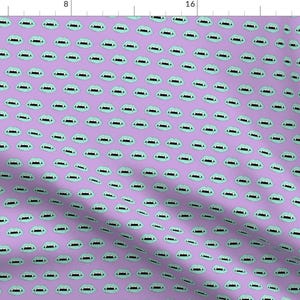 May include: A repeating pattern of light blue vampire fangs on a lavender background. The fangs are outlined in black.