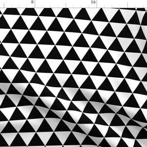 May include: Black and white geometric pattern with repeating triangles. The triangles are arranged in a staggered pattern, creating a dynamic visual effect.