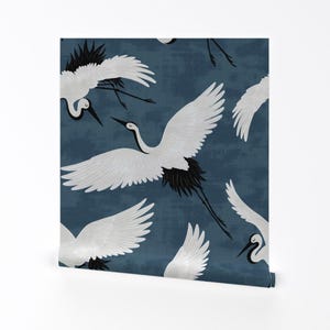 May include: A blue background with a repeating pattern of white cranes with black accents. The cranes are flying in different directions.