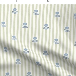 May include: Fabric with a repeating pattern of blue floral designs on a striped background. The stripes alternate between white and a muted green color. The floral pattern is a simple, stylized design.