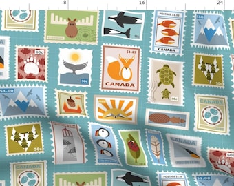 May include: A blue and white patterned fabric with a repeating design of postage stamps featuring Canadian wildlife and landmarks. The stamps feature images of a moose, a whale, a fox, a turtle, a lighthouse, a puffin, a mountain range, a forest, and a sunrise. The stamps also feature the word "CANADA" and various prices in Canadian dollars.