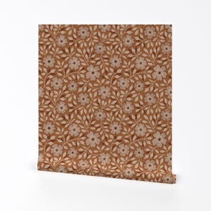 May include: A brown and white floral pattern wallpaper with a repeating design of small white flowers and brown leaves.