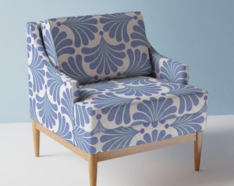 May include: A blue and white patterned armchair with a wooden frame and legs. The chair has a high back and a comfortable seat.