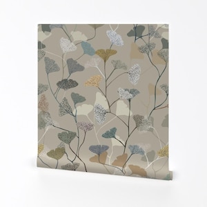 May include: A seamless pattern featuring stylized ginkgo leaves in shades of beige, brown, blue, and green on a light beige background.
