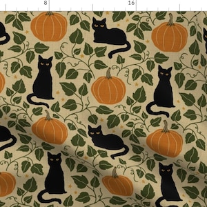 May include: A fabric print featuring a repeating pattern of black cats with yellow eyes, orange pumpkins, and dark green ivy vines on a light tan background. The design includes small yellow stars scattered throughout the botanical foliage.