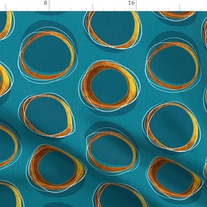 May include: Teal blue fabric with a repeating pattern of overlapping circles in gold and white.