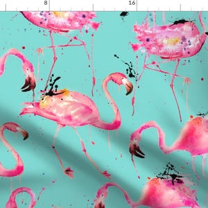 May include: A seamless pattern featuring pink flamingos with black accents on a turquoise background. The flamingos are painted in a watercolor style with splatters of paint.