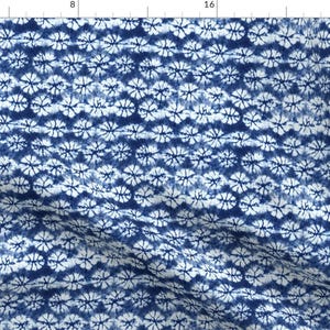 May include: A seamless pattern of blue and white tie-dye circles. The circles are arranged in a repeating pattern, creating a visually appealing design.