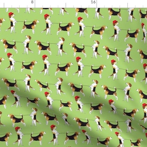 May include: A repeating pattern of beagle dogs wearing red hats and walking on a green background. Each dog is holding a leash and is walking in the same direction.