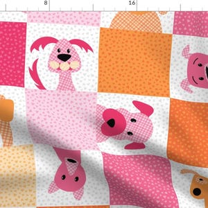 May include: A patchwork fabric design featuring pink and orange squares with white polka dots. Each square has a cartoon dog face with different expressions. The fabric is perfect for quilting, sewing, and crafting projects.