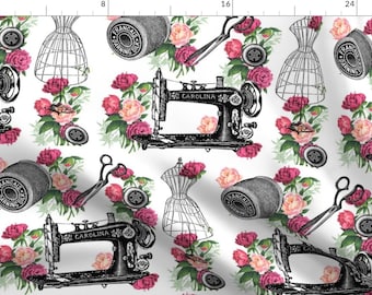 May include: A white background with a repeating pattern of pink peonies, vintage sewing machines, spools of thread, scissors, and dress forms. The text "Francais" and "Carolina" are visible on the sewing machines.