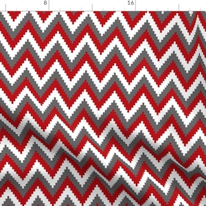 Puede incluir: Tela con patrón de chevron rojo, blanco y gris. El patrón está hecho de cuadrados pequeños.