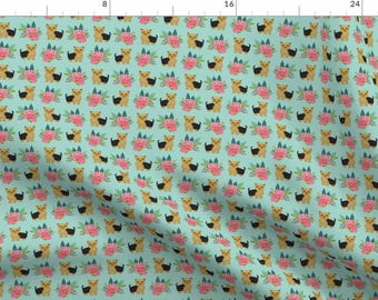 May include: A seamless pattern featuring a repeated design of a small, light brown dog with black ears and a black tail, standing in front of a pink flower bouquet on a light blue background.